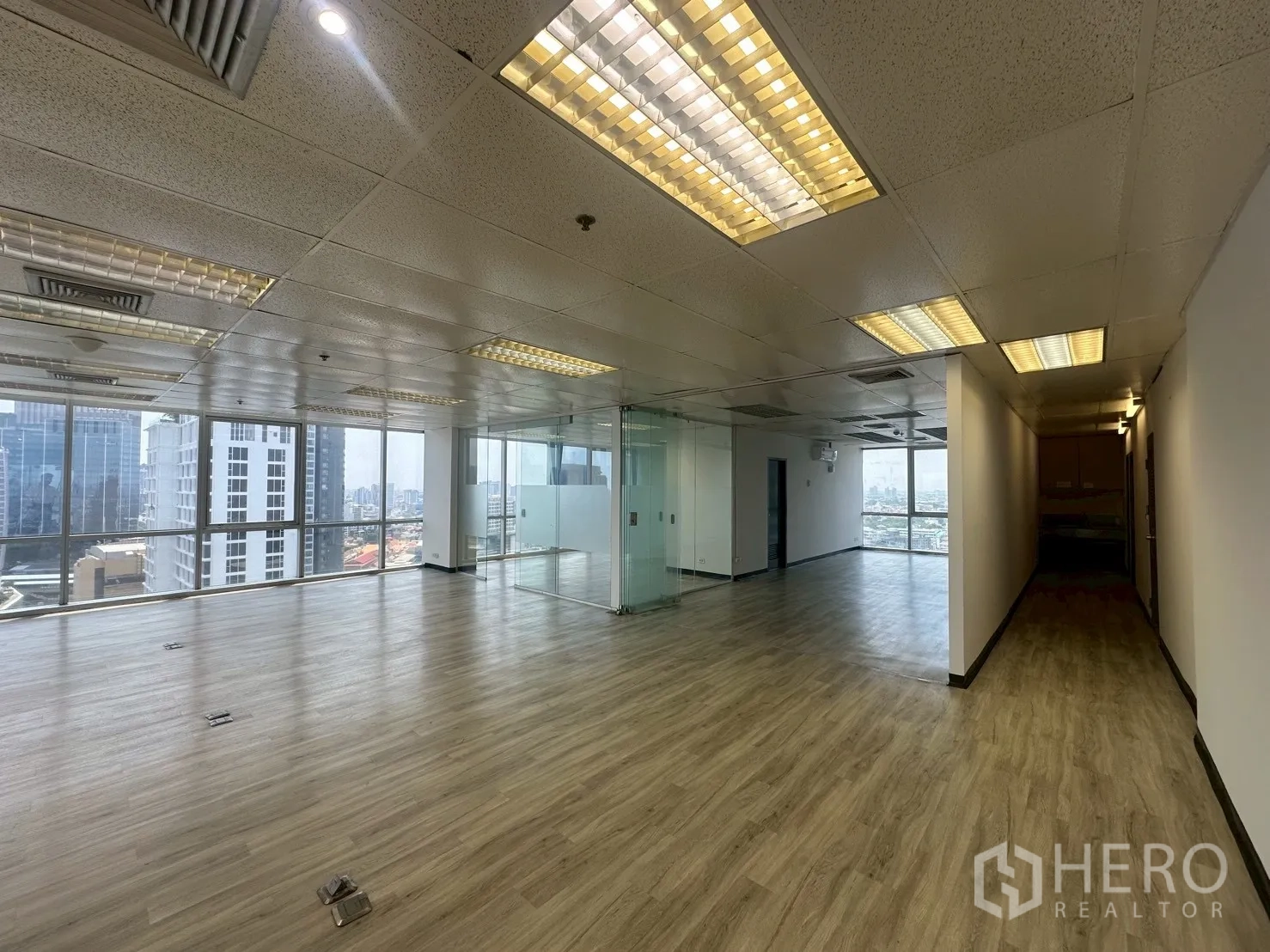 Office Space for rent - Open plan space connecting to glass meeting rooms and a windowed corner with skyline views.