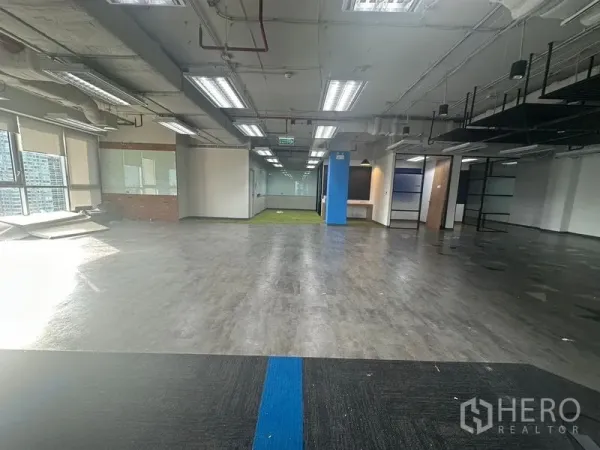 Office Space for rent in Bang Rak, Bangkok - Spacious open-plan office floor with mixed flooring finishes and large windows.