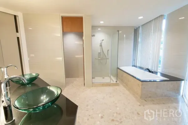 Condominium for rent - Spa-style bathroom with double glass vessel sinks, glass shower and soaking tub.