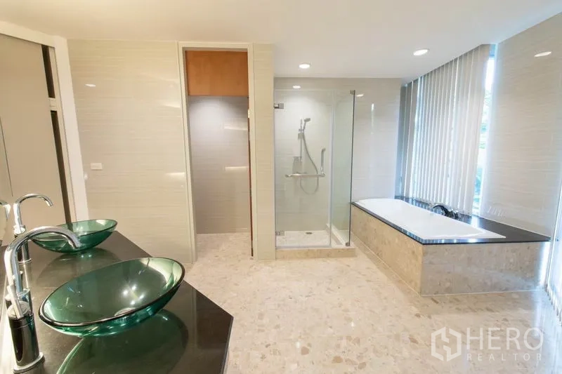 Condominium for rent - Spa-style bathroom with double glass vessel sinks, glass shower and soaking tub.