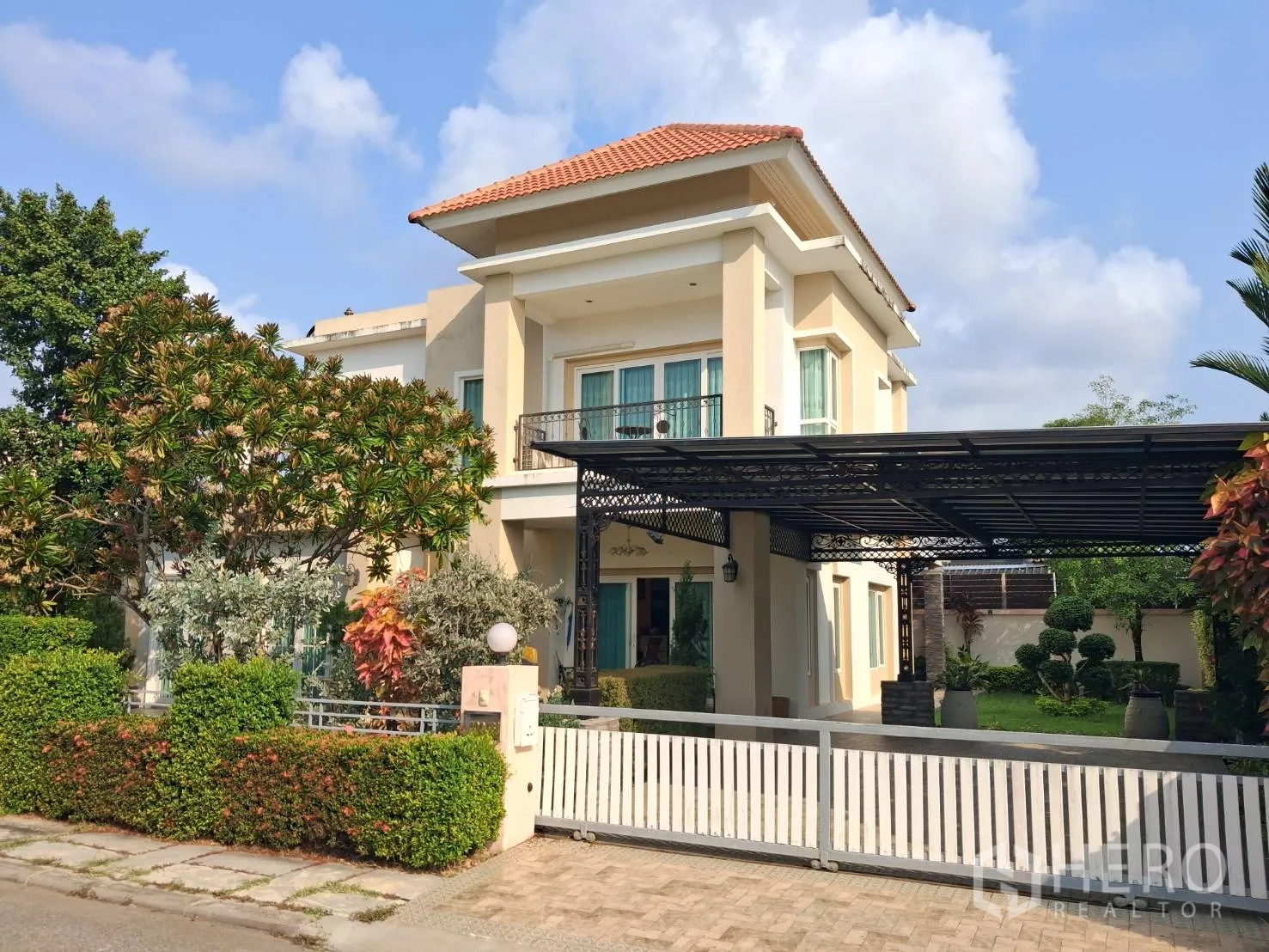 Detached House for rent or sale in Ban Chang, Rayong - Angled exterior showing tiled roof home, carport and front fence.