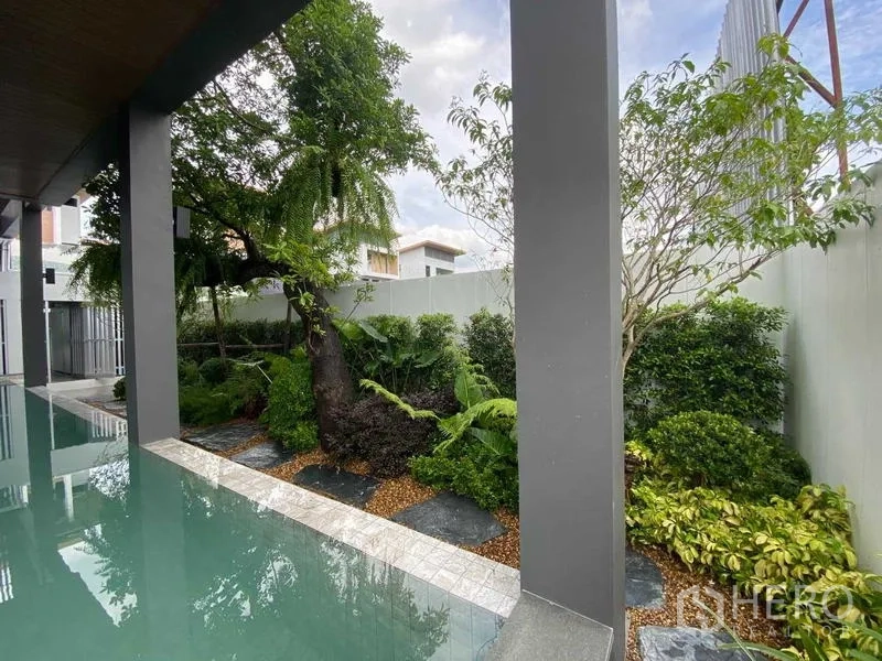 Detached House for rent or sale in Prawet, Bangkok - Lush garden beside a covered pool with stepping-stone path.
