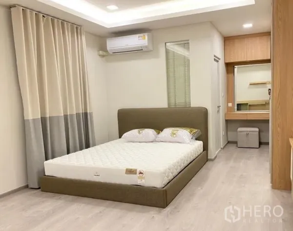 Detached House for rent - Master bedroom with upholstered bed, air conditioner, and vanity area.