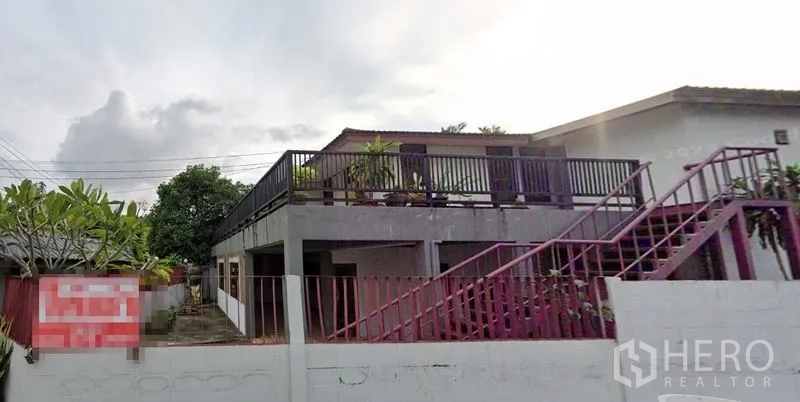 Home Office for rent in Watthana, Bangkok - Two-storey home office exterior with rooftop terrace and red metal stairs in Watthana.