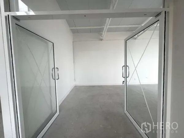 Office Space for rent in Bang Rak, Bangkok - Glass double-door entrance to a meeting room or private office within a minimalist white workspace.