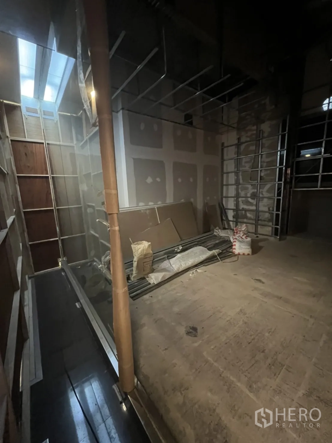 零售空间 出租在Watthana, Bangkok - 未完成的铺位内部，层高开阔，石膏板与施工材料可见。