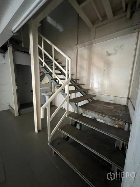 Shophouse for rent in Watthana, Bangkok - Close-up of steel stairway and handrails in a service area.