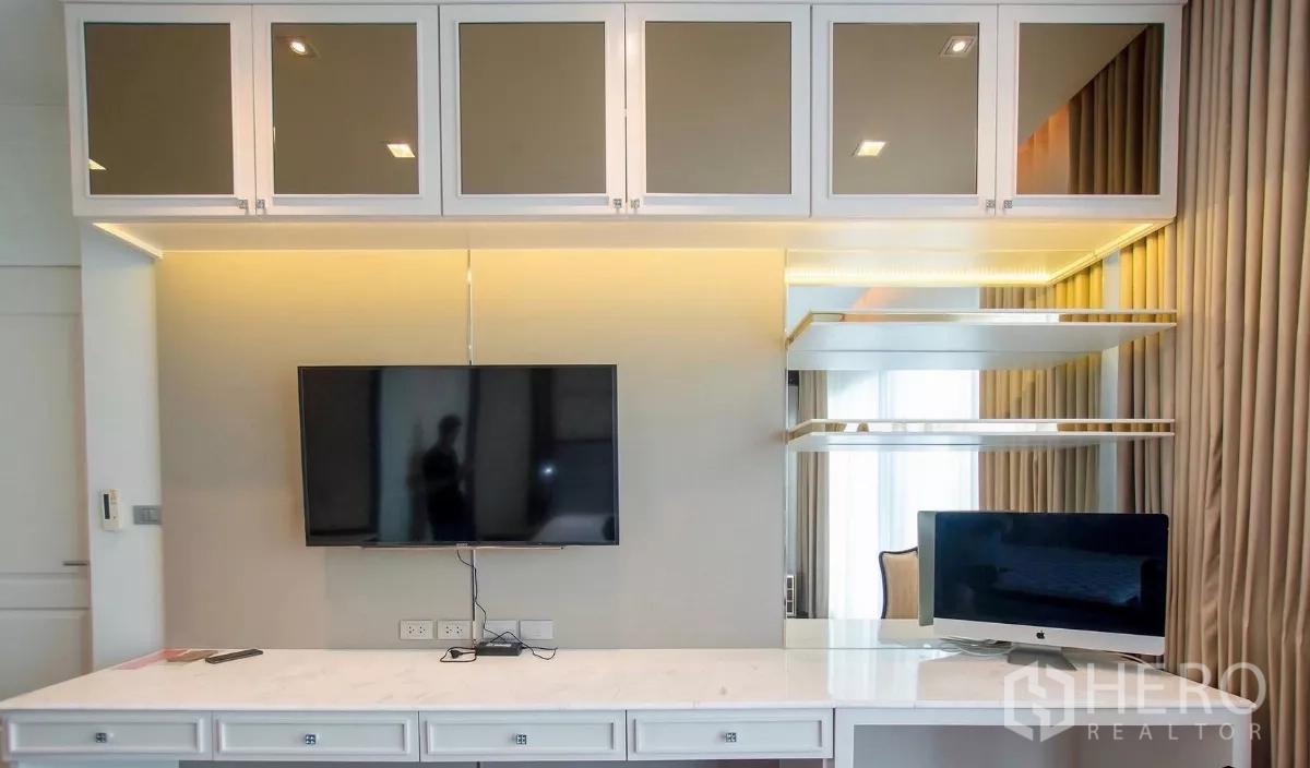 Detached House for rent in Bang Bon, Bangkok - Detail of study desk with shelving, mirrored cabinets and TV.