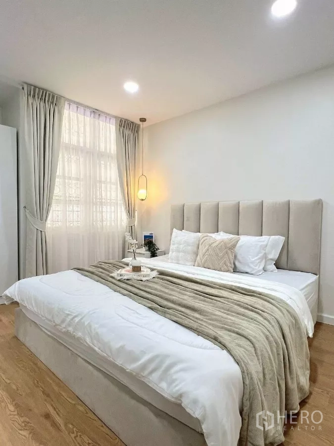 บ้าน ให้เช่าในHuai Khwang, Bangkok - ห้องนอนหลักมุมกว้าง หัวเตียงบุผ้า โคมแขวน และชุดเครื่องนอนแบบเลเยอร์