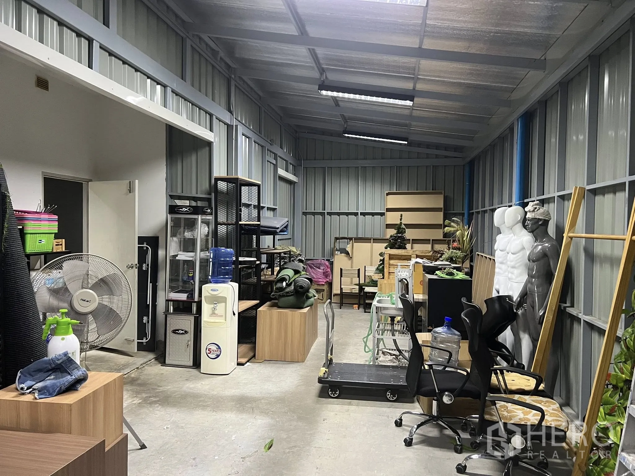 Detached House for rent or sale in Don Mueang, Bangkok - Covered stock room with metal walls and various equipment stored.