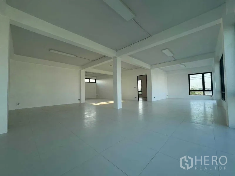 Home Office for rent in Don Mueang, Bangkok - Large open office floor with multiple windows, white tiled floor and ceiling lights.