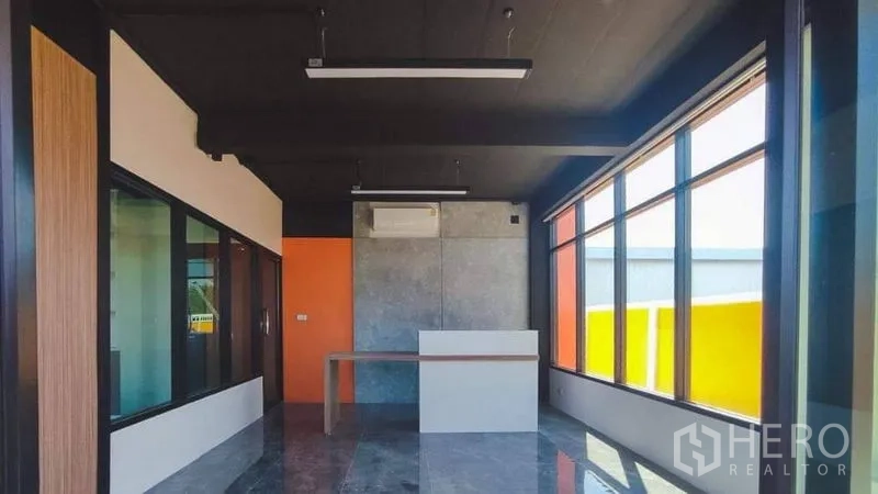 Factory for sale in Bang Pakong, Chachoengsao - Reception and showroom area with floor-to-ceiling windows and polished tiles