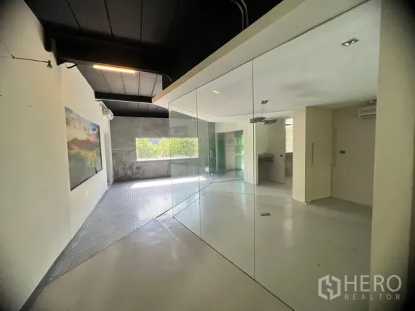 Warehouse for rent in Suan Luang, Bangkok - Modern glass-partitioned office area with polished floors and natural light.