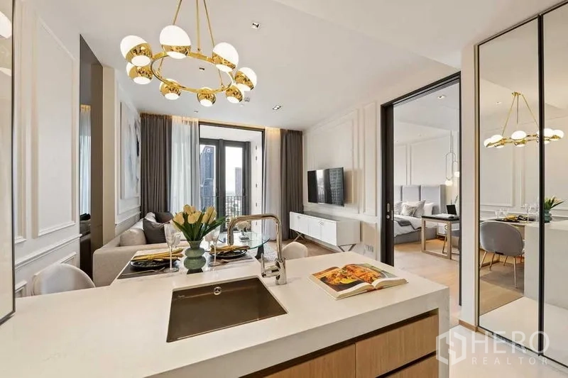 公寓 出租或出售在Khlong Toei, Bangkok - 开放式厨房与客厅，金色吊灯并可通往阳台。