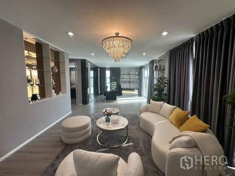 Factory for sale in Lam Luk Ka, Pathum Thani - Executive lounge with chandelier, curved sofa and full-height curtains.