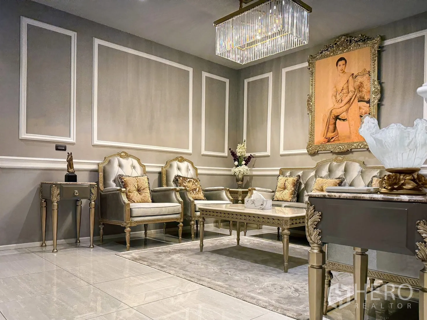 Detached House for rent or sale in Lak Si, Bangkok - Formal living room with tufted silver seating, crystal light, and paneled walls.