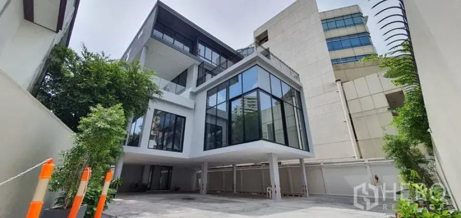Home Office for rent or sale in Watthana, Bangkok - Contemporary glass‑fronted home office building with driveway and greenery.