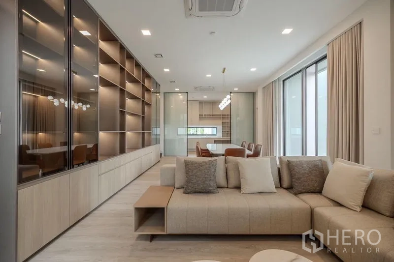 Detached House for rent in Saphan Sung, Bangkok - Open-plan living and dining area with a wall of display shelves.