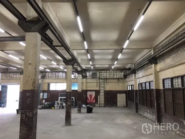 货栈 出租在Lak Si, Bangkok - 大面积生产作业区，成排立柱、通风砖与线性照明。