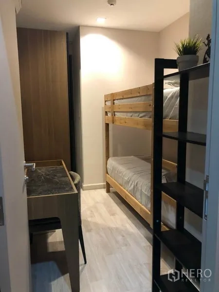 Condominium for rent or sale in Phra Khanong, Bangkok - Second bedroom with bunk beds, study desk and shelving unit.