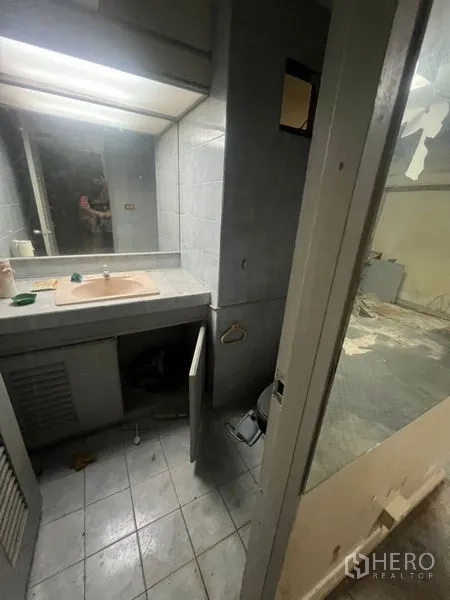 零售空间 出租在Watthana, Bangkok - 小型洗手间，灰色瓷砖，带洗手台和镜子。