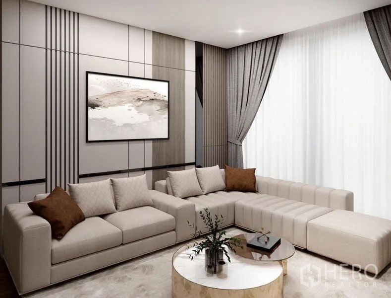 Detached House for sale in Suan Luang, Bangkok - Modern lounge featuring an L-shaped sectional, decorative panel wall and large curtains.