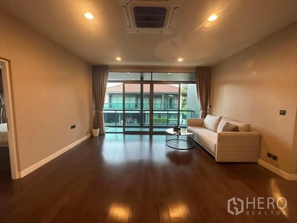 Detached House for rent in Bang Kapi, Bangkok - Upstairs family room with warm wood floors and wide sliding doors to the balcony.
