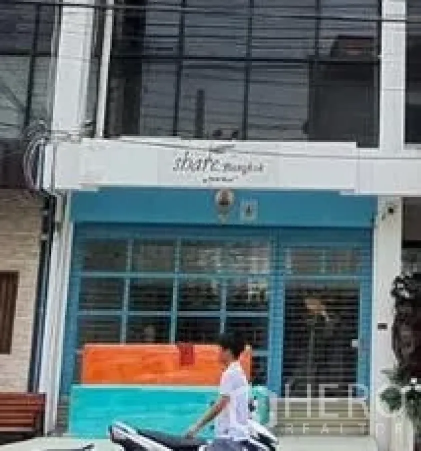 Home Office for rent in Khlong Toei, Bangkok - Street-facing home office facade with blue-framed glass storefront on Sukhumvit.