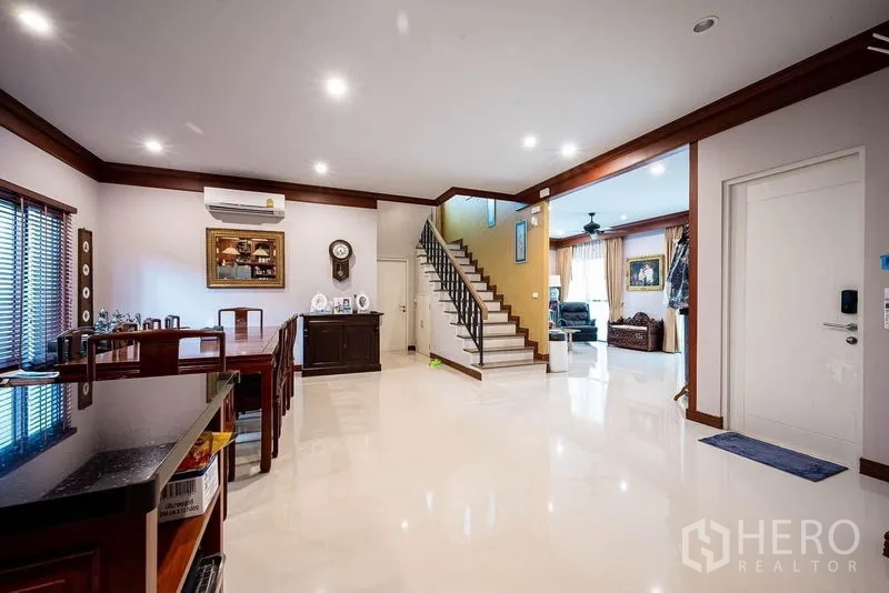 Detached House for sale in Prawet, Bangkok - Open-plan dining and family area with staircase and bright floors.