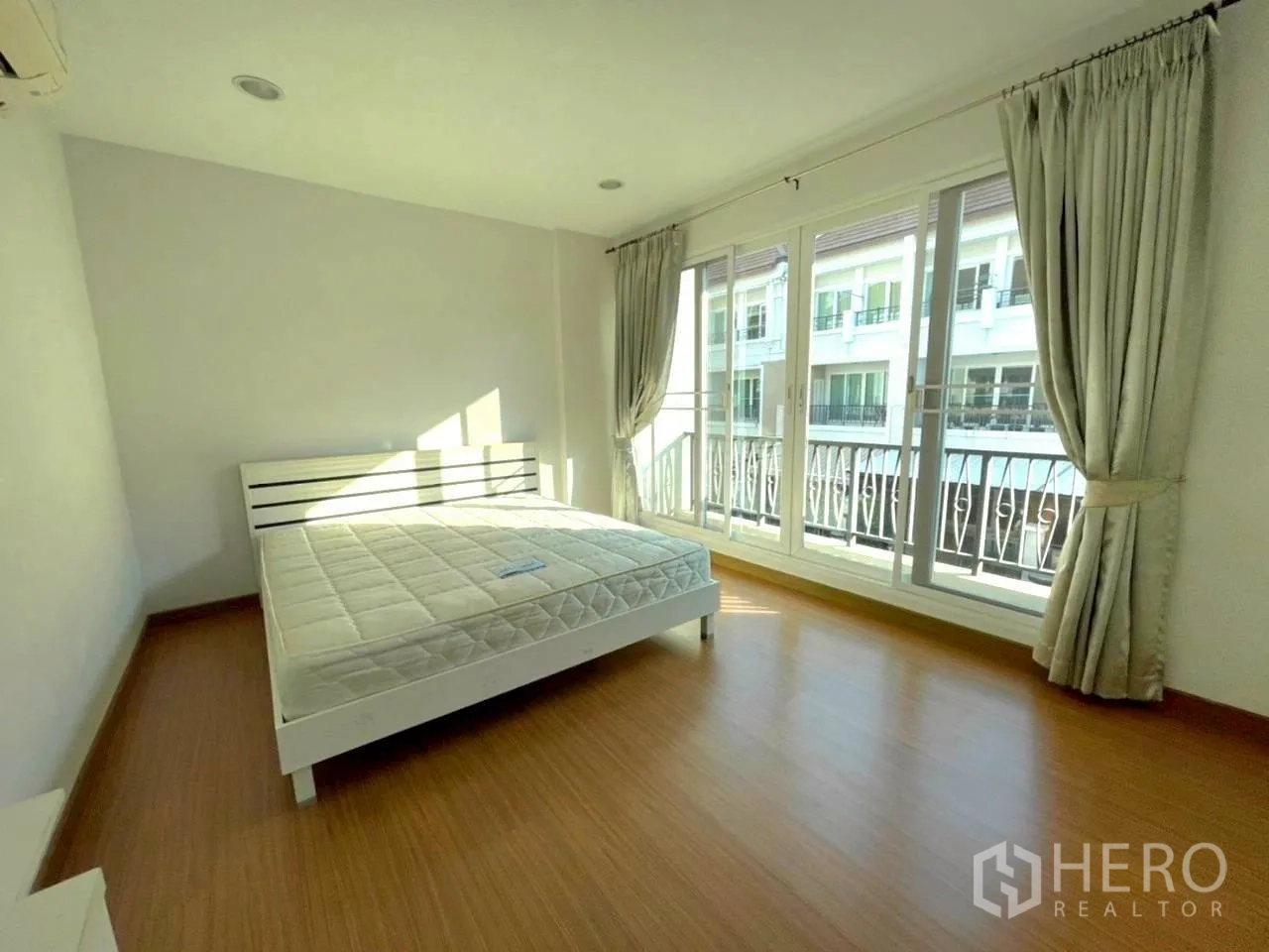 联排别墅 for rent in Bang Kho Laem, Bangkok - 大卧室带床，整面推拉落地窗通向阳台。
