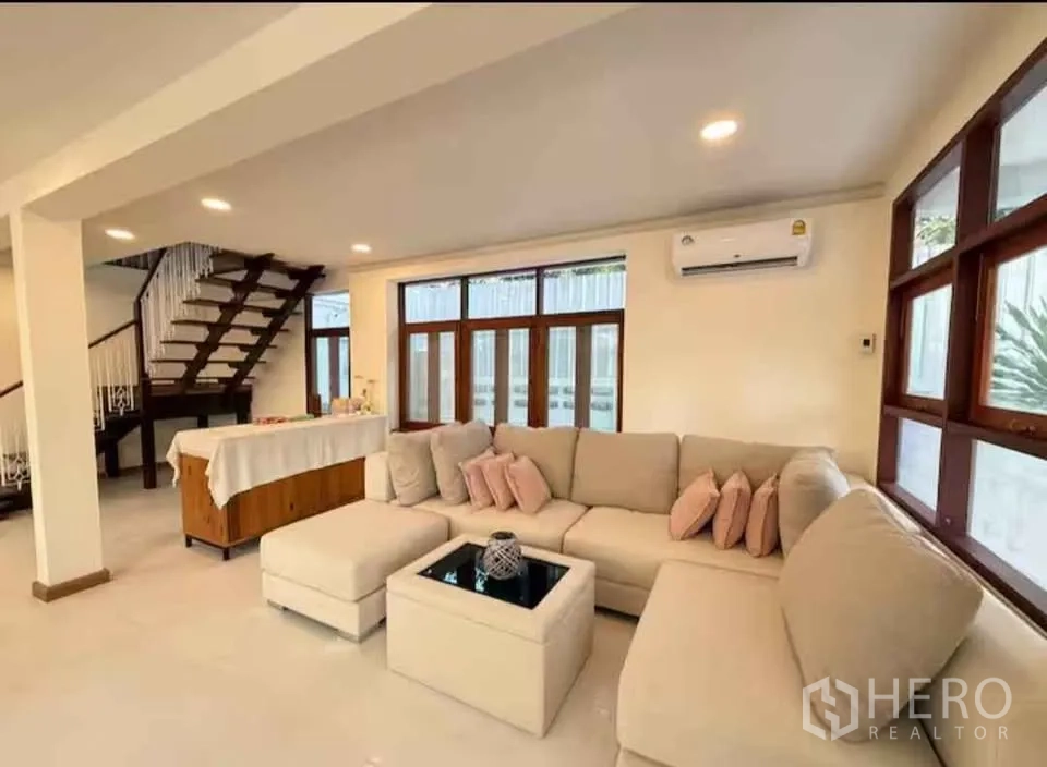 บ้าน ให้เช่าในKhlong Toei, Bangkok - ห้องนั่งเล่นกว้าง โซฟามุม แอร์ หน้าต่างยาว และบันไดไม้