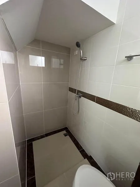 Detached House for rent - Tiled shower area with handheld showerhead and accent border.