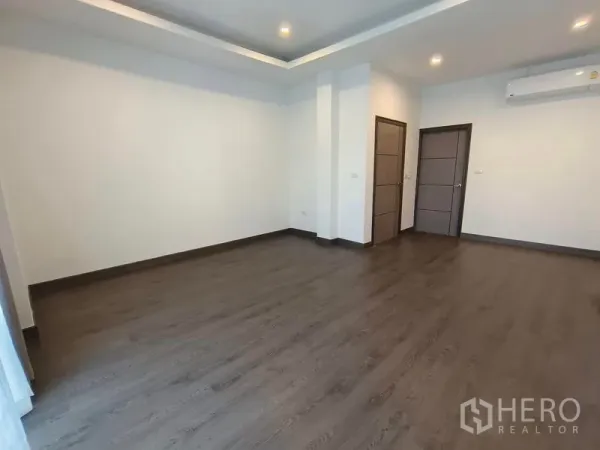 Detached House for rent or sale - Spacious empty bedroom with dark wood flooring, recessed lights, and air conditioning.