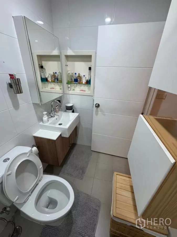 Condominium for rent in Watthana, Bangkok - Second bathroom with dual sinks, vanity storage and toilet.