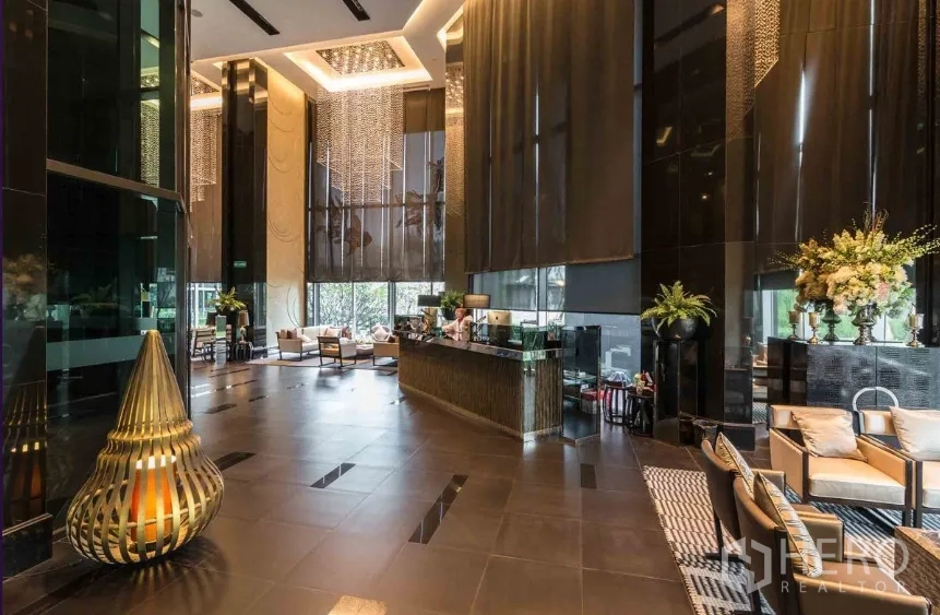Condominium for rent in Sathon, Bangkok - Luxury double-height condo lobby with chandeliers, reception desk and lounge seating in Sathon.