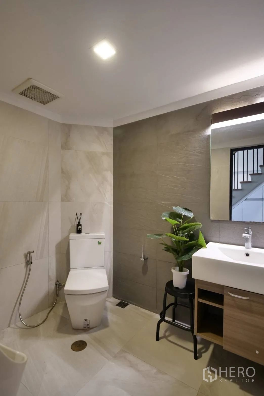 Townhouse for rent in Khlong Toei, Bangkok - Guest bathroom with toilet, vanity and indoor plant.