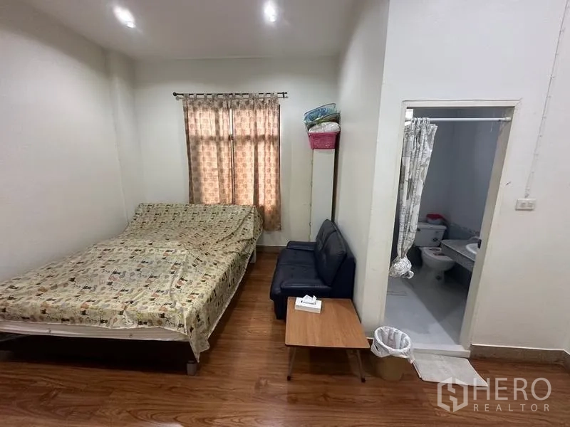 Home Office for sale in Phra Pradaeng, Samut Prakan - Compact bedroom with window, small sofa and an en-suite bathroom.