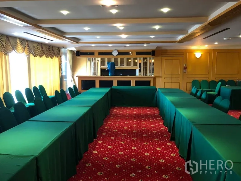 Office Space for rent in Bang Na, Bangkok - Large conference room with U-shaped tables, red carpet, draped windows and a coffered ceiling.