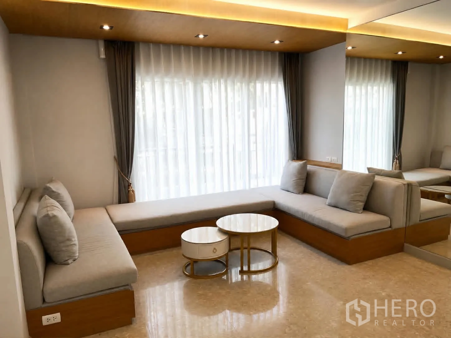 Detached House for rent or sale in Saphan Sung, Bangkok - Cozy lounge with built-in L-shaped sofas and coffee tables.