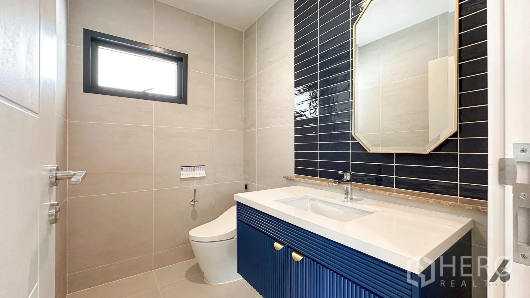 Detached House for rent in Bang Phli, Samut Prakan - Contemporary bathroom with navy vanity, white countertop, and dark subway tile accent wall.