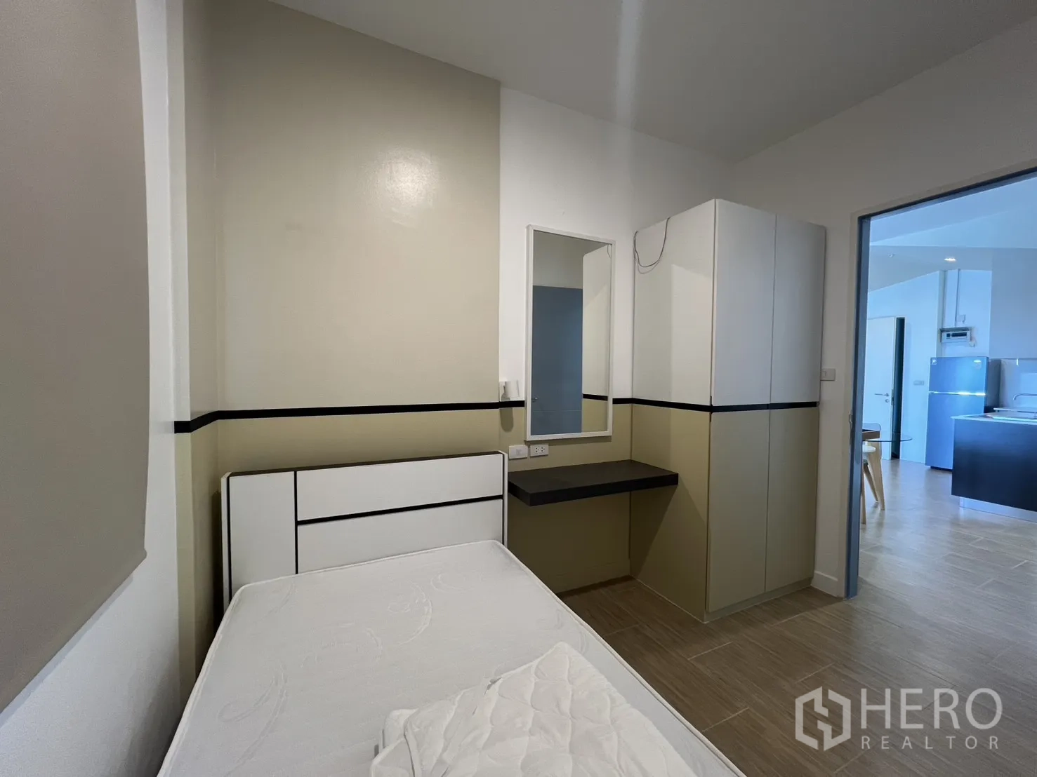 Condominium for rent in Bang Kapi, Bangkok - Single bedroom view showing a window with roller blind and vanity.