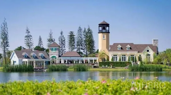 Detached House for sale in Samut Prakan - European-style clubhouse and tower beside a tranquil lake in the community.