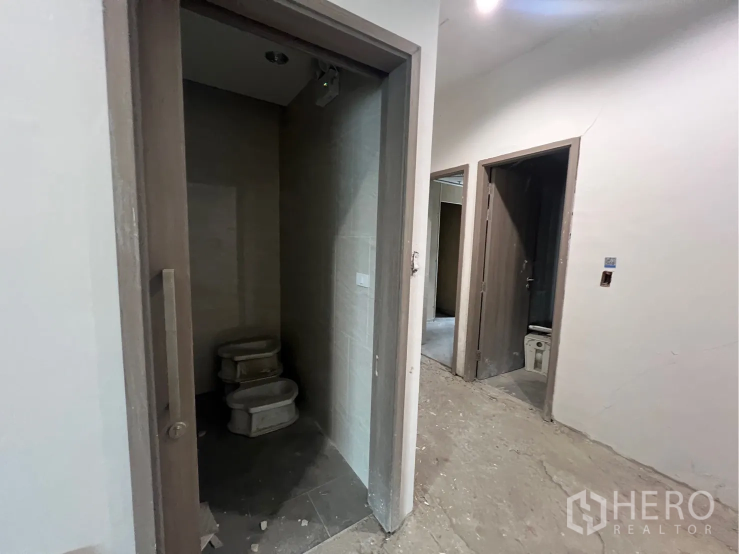 Office Space for rent in Khlong Toei, Bangkok - Partially finished restrooms inside the office unit with tiled walls and door frames installed.