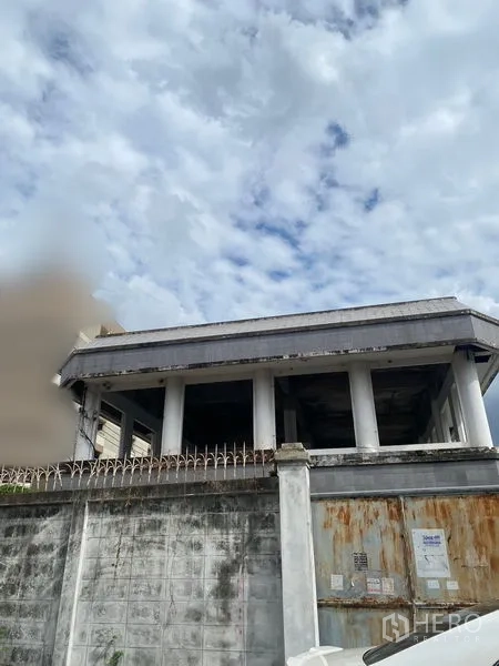 Office Space for sale in Wang Thonglang, Bangkok - Exterior view from outside the compound showing the upper floor and spiked fence.