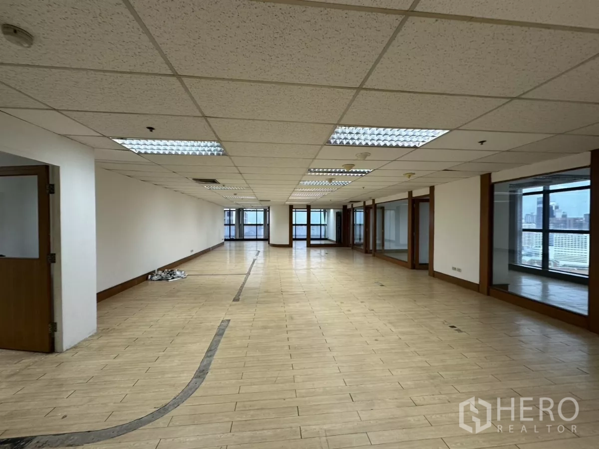 Office Space for rent in Watthana, Bangkok - Large open office zone with glass walls, natural light, and pale wood-effect tiles.