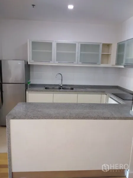 คอนโด ให้เช่าในKhlong Toei, Bangkok - ครัวรูปตัวแอล เคาน์เตอร์หินแกรนิต อ่างล้างจานสองหลุม ตู้ลอยบานกระจก และตู้เย็นสเตนเลส