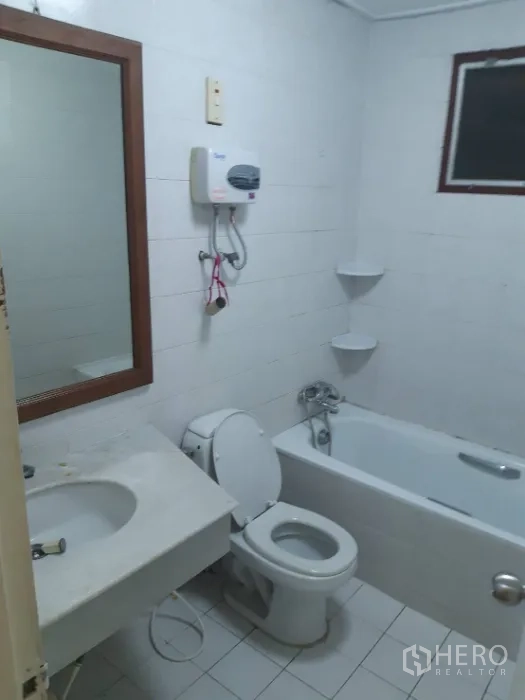 ทาวน์เฮาส์ ให้เช่าในKhlong Toei, Bangkok - ห้องน้ำปูกระเบื้องสีขาว พร้อมอ่างอาบน้ำ โถสุขภัณฑ์ เคาน์เตอร์ล้างหน้า และเครื่องทำน้ำอุ่น