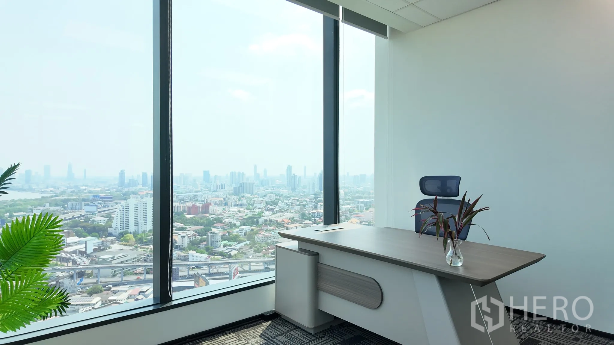 Office Space for rent in Khlong Toei, Bangkok - Bright executive office with panoramic city views through tall windows.