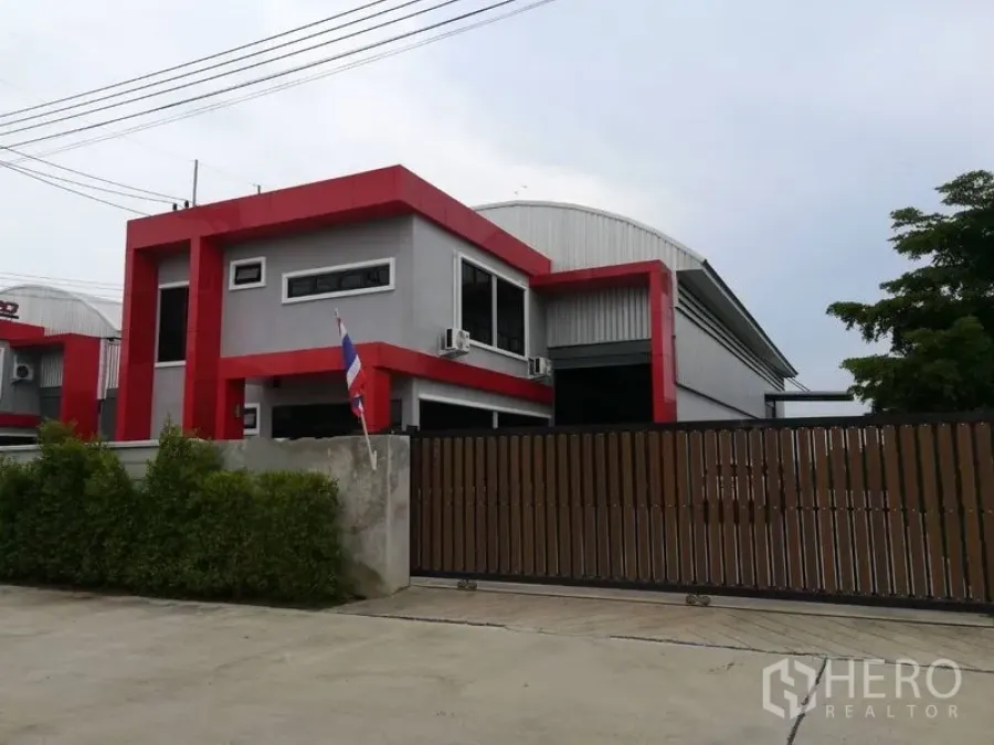 Factory for sale in Bang Len, Nakhon Pathom - Modern grey-and-red factory exterior with gated entrance in Bang Len, Nakhon Pathom.