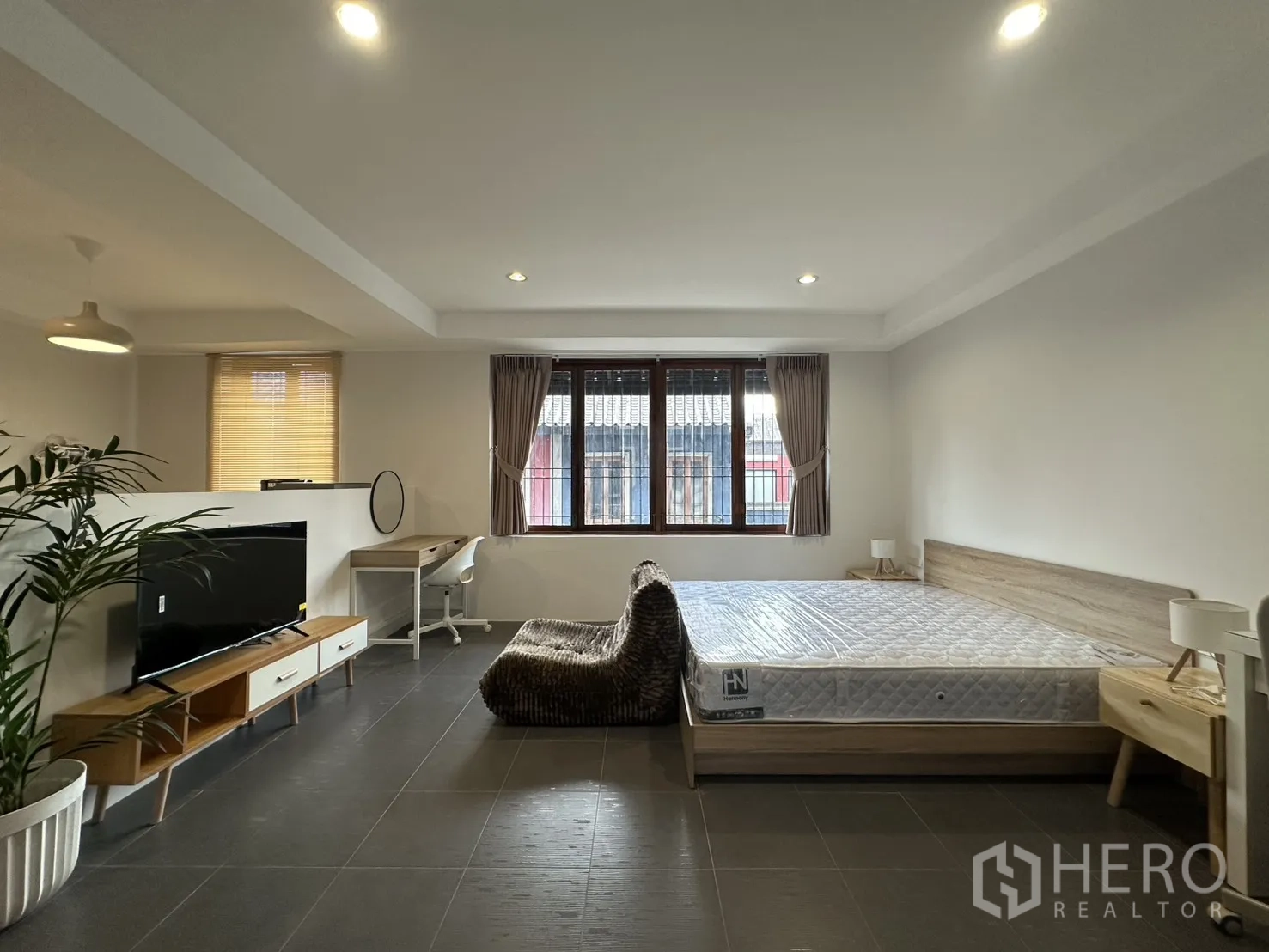 Apartment for rent in Pathum Wan, Bangkok - Pantry kitchen with storage cabinets, dining table, and refrigerator.